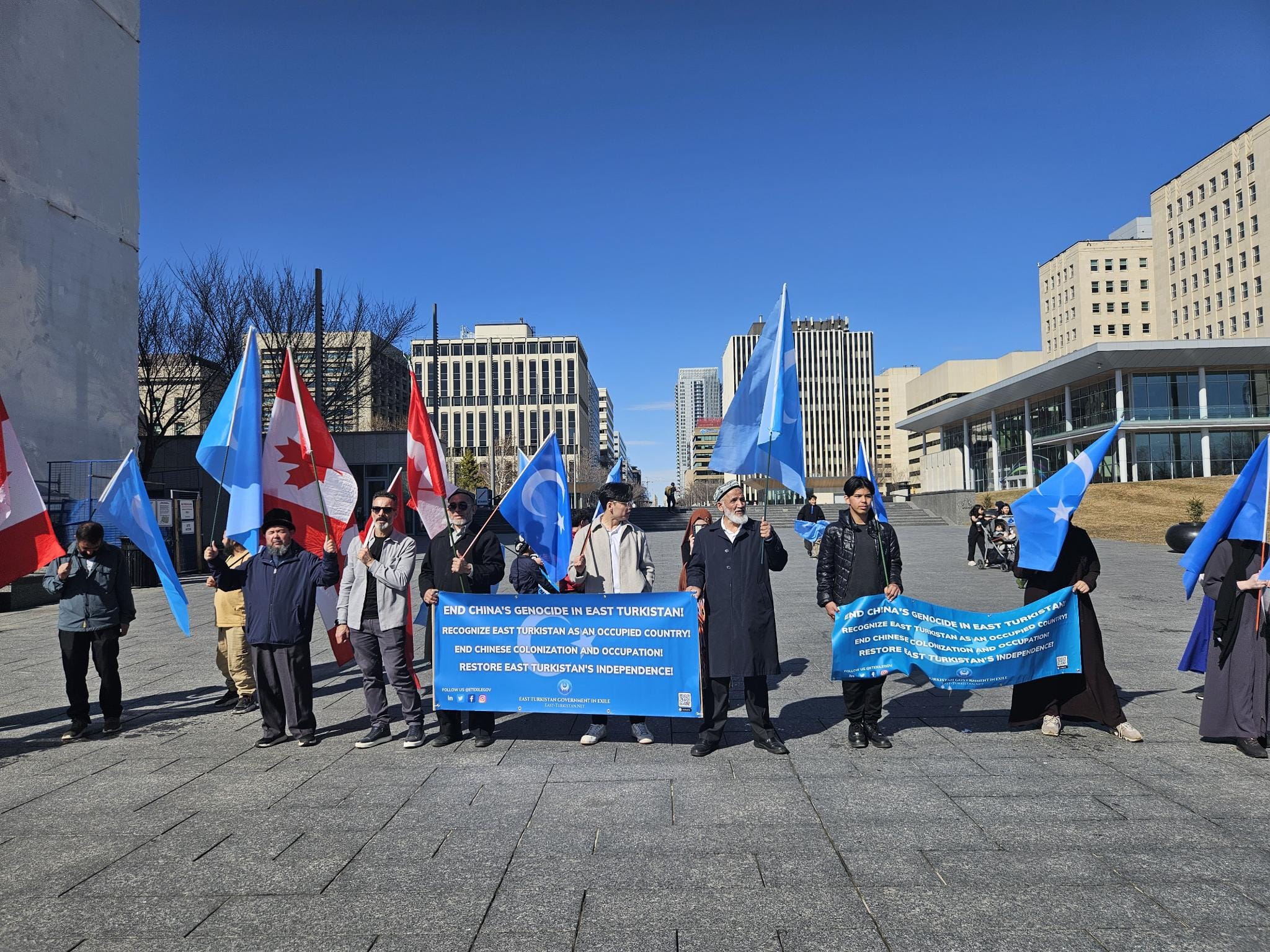 Demonstrators holding banners reading End China's genocide in East Turkistan.
